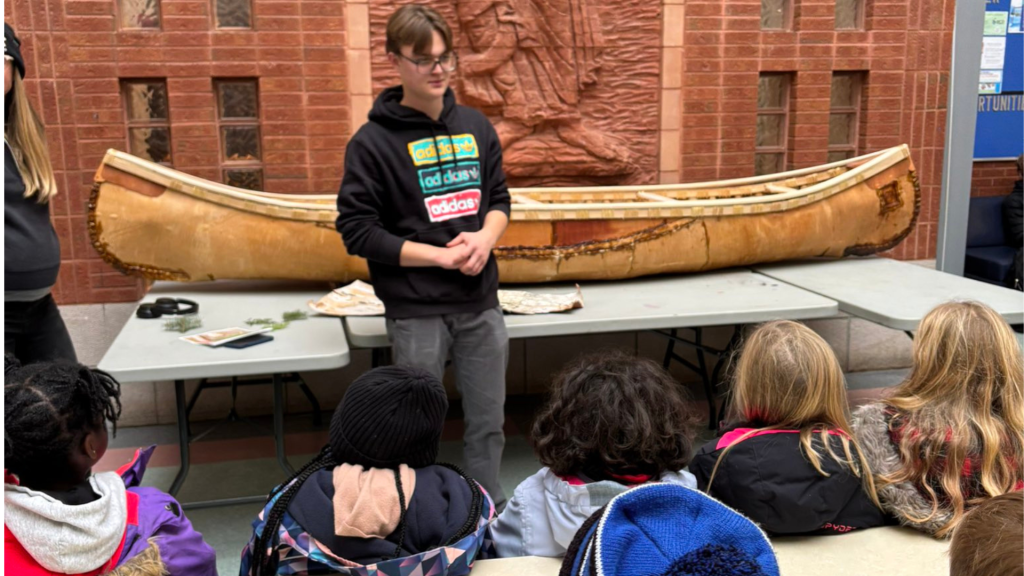 Students watch a presentation about Canoes