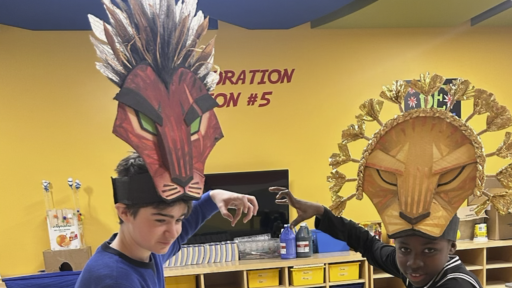 Students rehearsing while wearing headpieces for the Lion's King performance