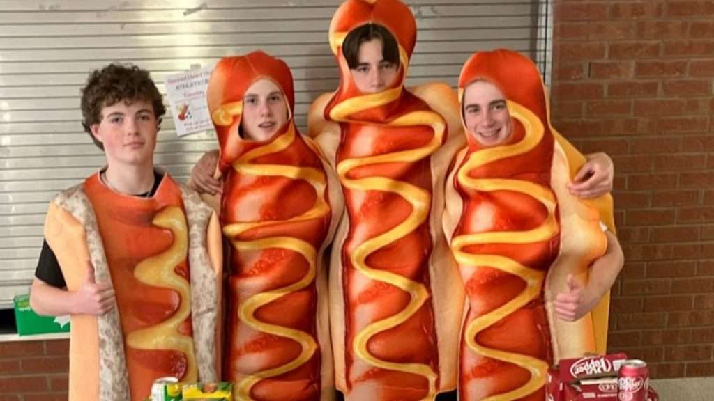 Students wearing their hot dog costumes by their food stand
