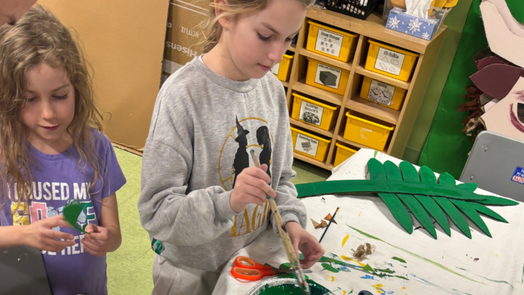 Students working on the backstage to prepare for the Lion's King Jr Play