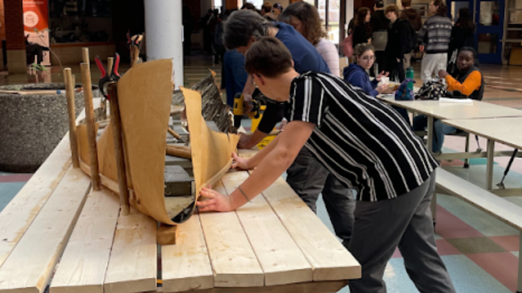 Students and instructors building a traditional Canoe