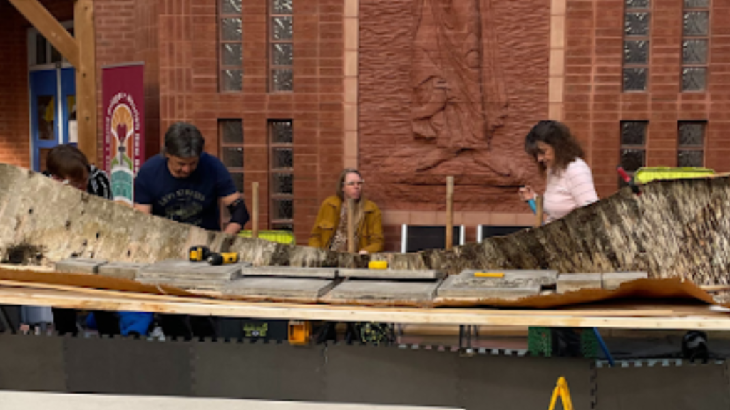 Students and instructors building a traditional Canoe