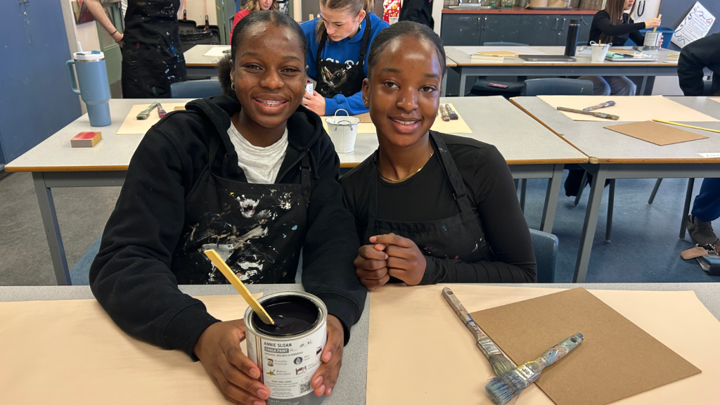 Students in their classroom at All Saints learning how paint