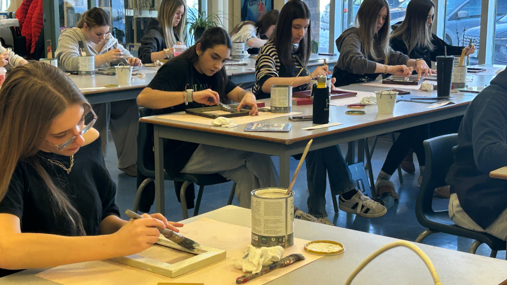 In a hands-on lesson on sustainability, All Saints students work on upcycling projects in class