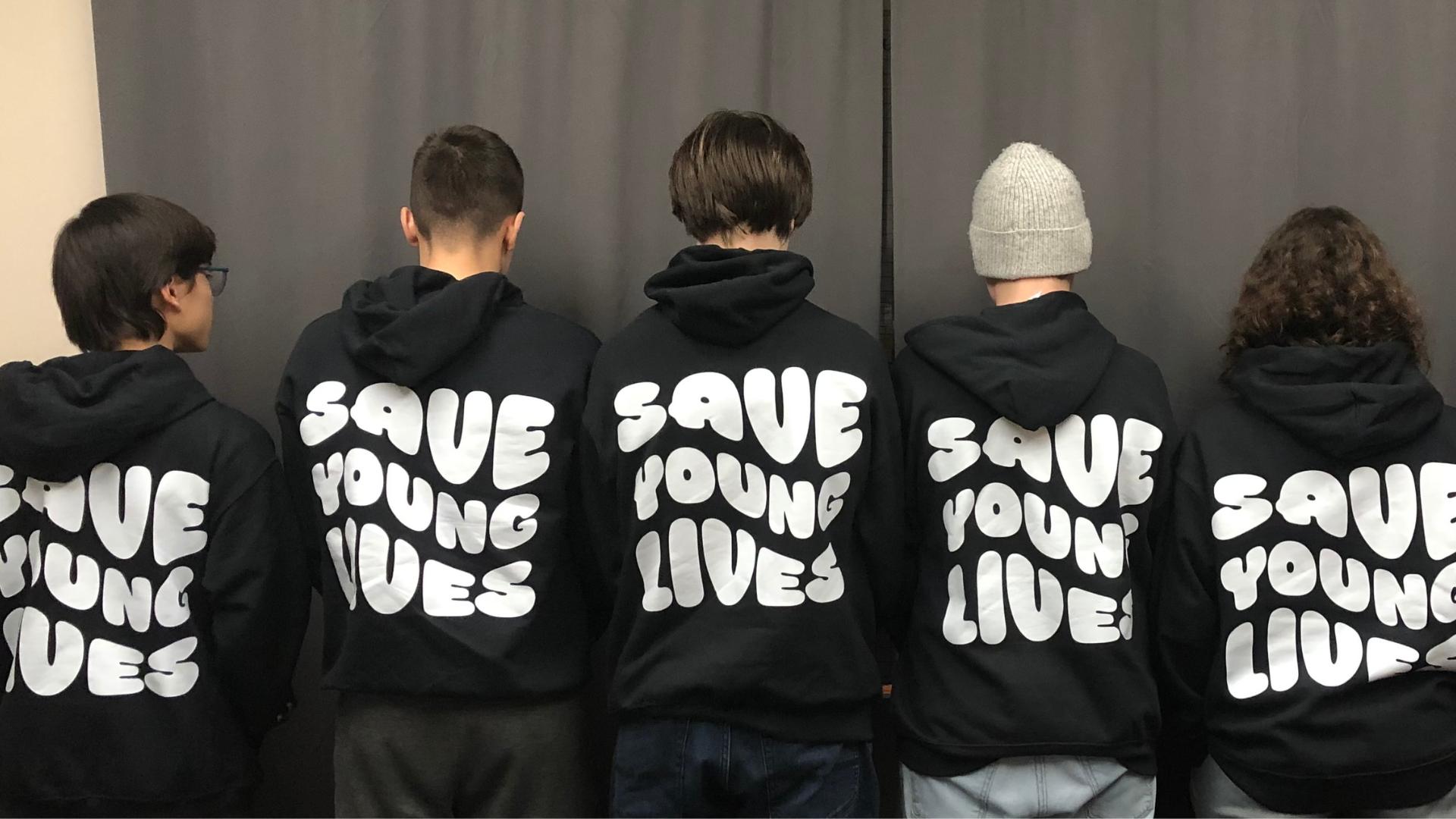 Five Holy Trinity students wearing their business sweatshirts printed "Save Young Lives"