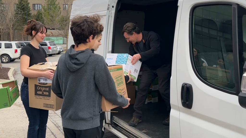 Students loading the truck with the sandwiches to be donated