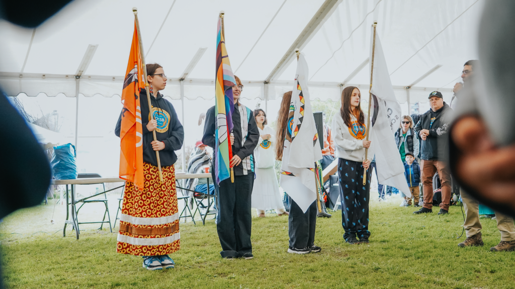 Students proudly showcasing their cultural identity and heritage holding their flags