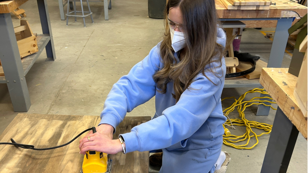 A student at All Saints dive into an upcycling project, turning old materials into something new