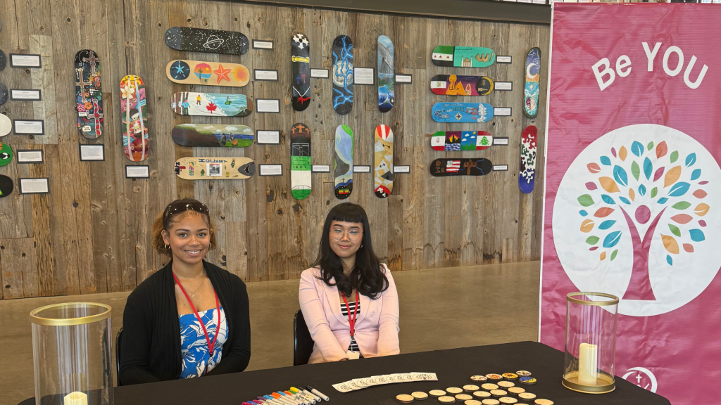 Students showcasing their work and welcoming the guests to their exposition