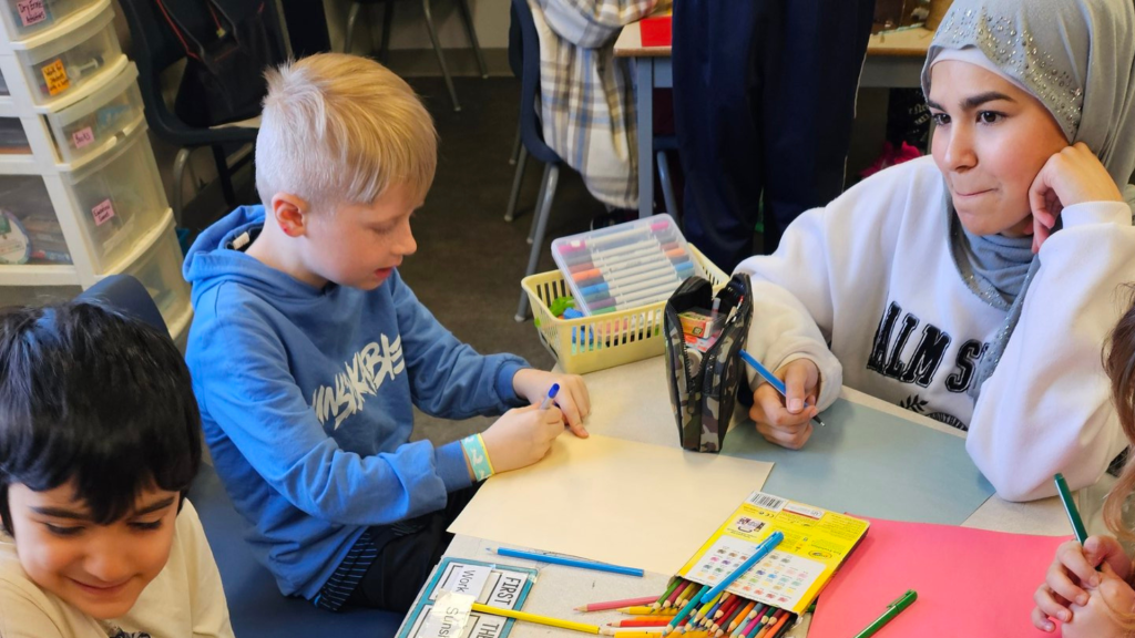 A student sharing the faith values to the younger children