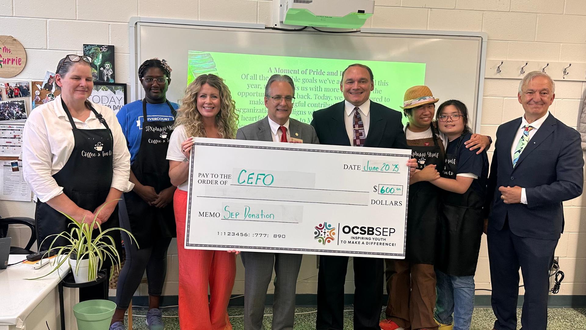 SPXpresso participants with Tom D'Amico receiving a cheque of donation to CEFO Foundation