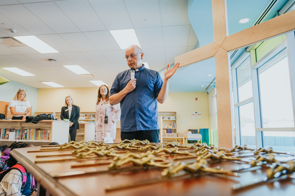 Father John blessing the crucifixes