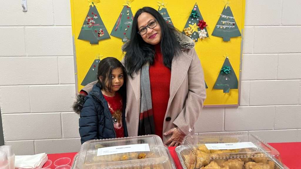 St Rose of Lima school family at their food table during Christmas event