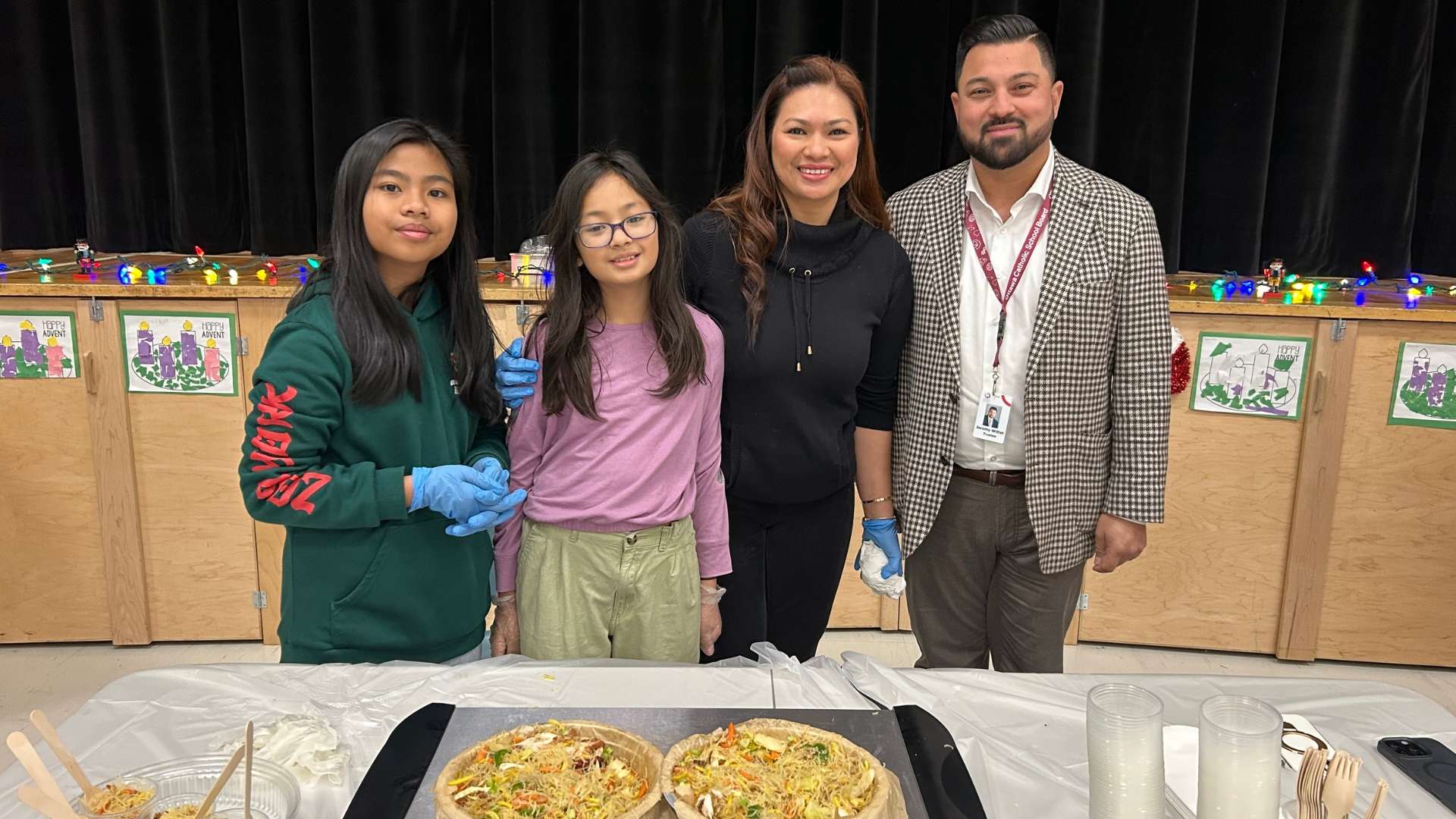 St Rose of Lima School family at their food table with school principal