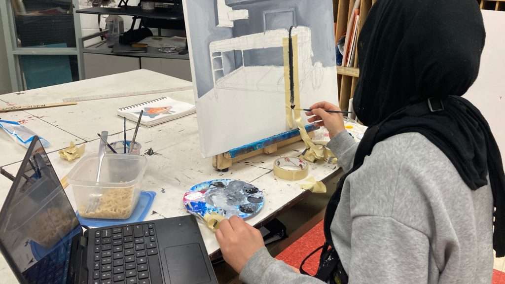 A student from St. Pius X creating artwork honouring women