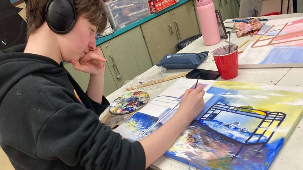 A student from St. Pius X creating artwork honouring women