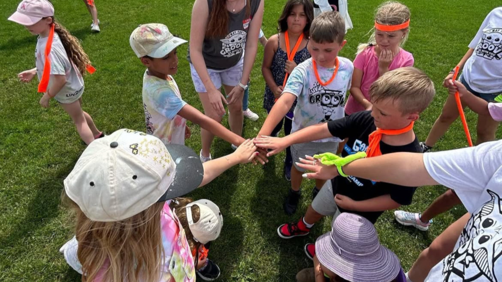 OCSB campers playing outdoors with Groove team
