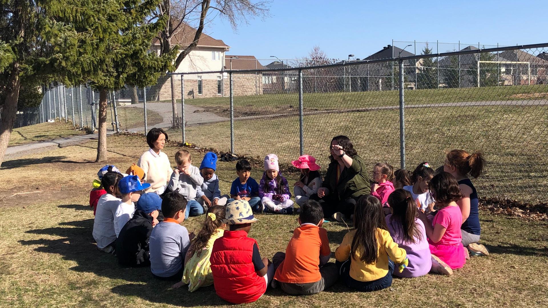 St. Anne's students learning outdoors with their teachers and peers