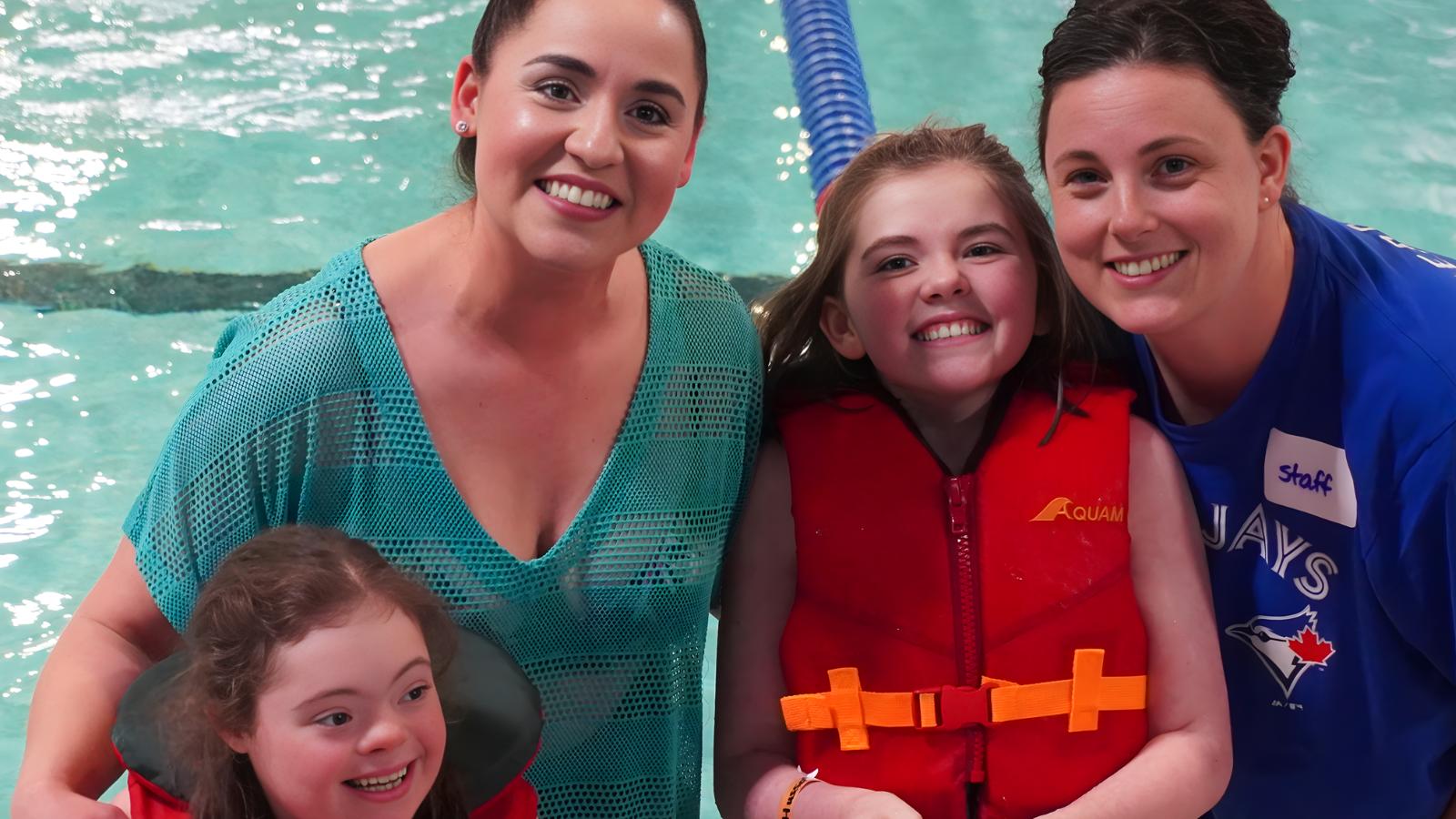Students by the pool at the Annual Swim Meet