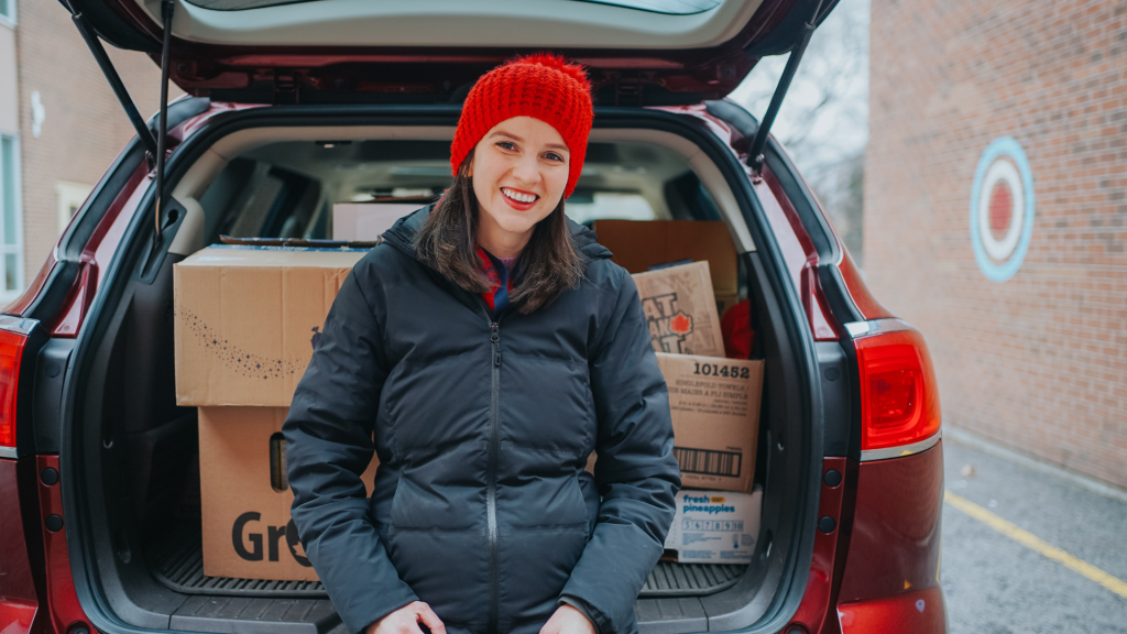 St Mary teacher by the car preparing donation bags