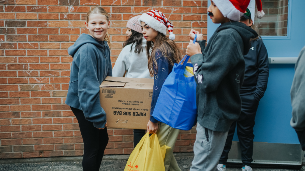 St. Mary's students carrying boxes and bags with donations